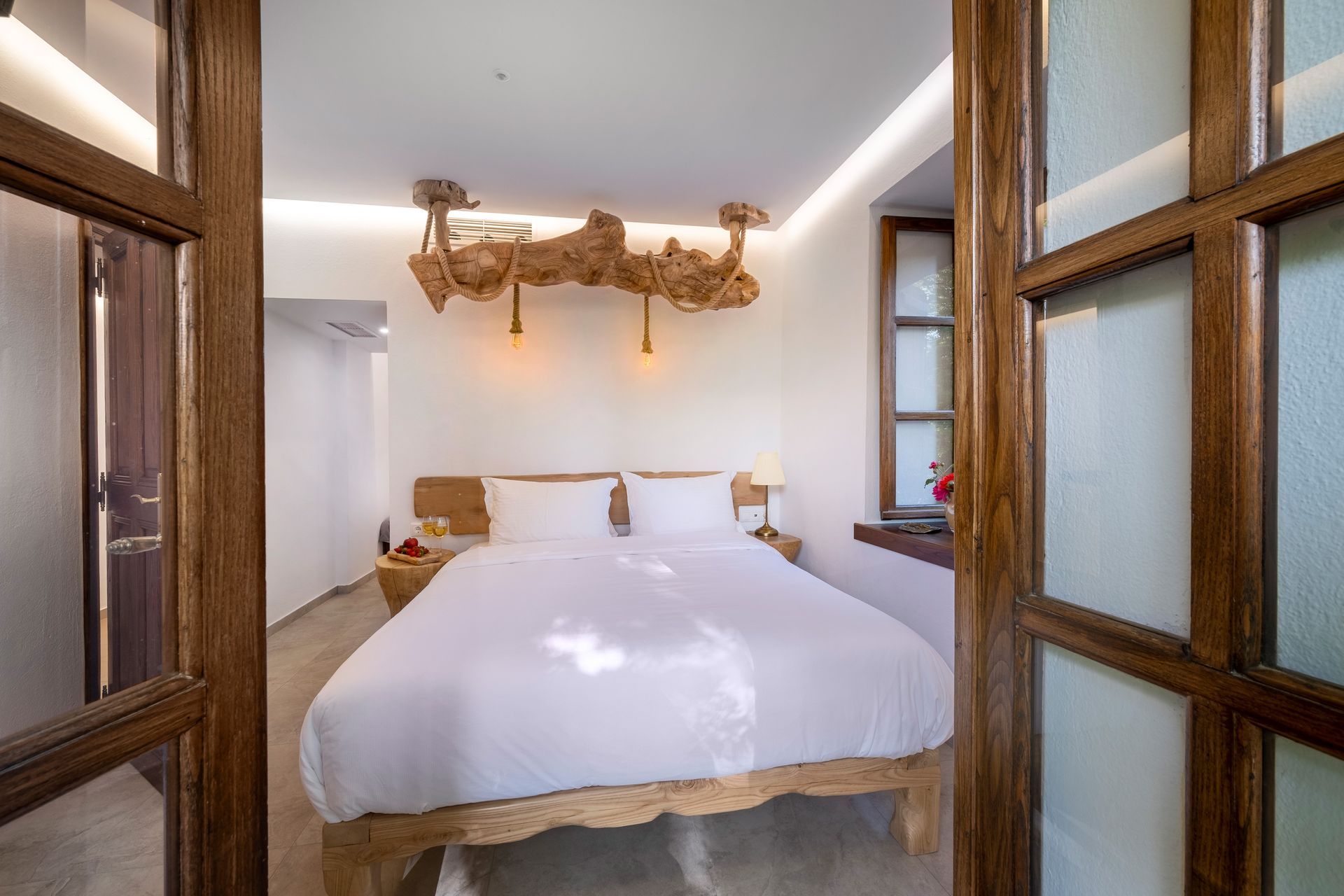 Bedroom interior with a bed, wood accents, and window.