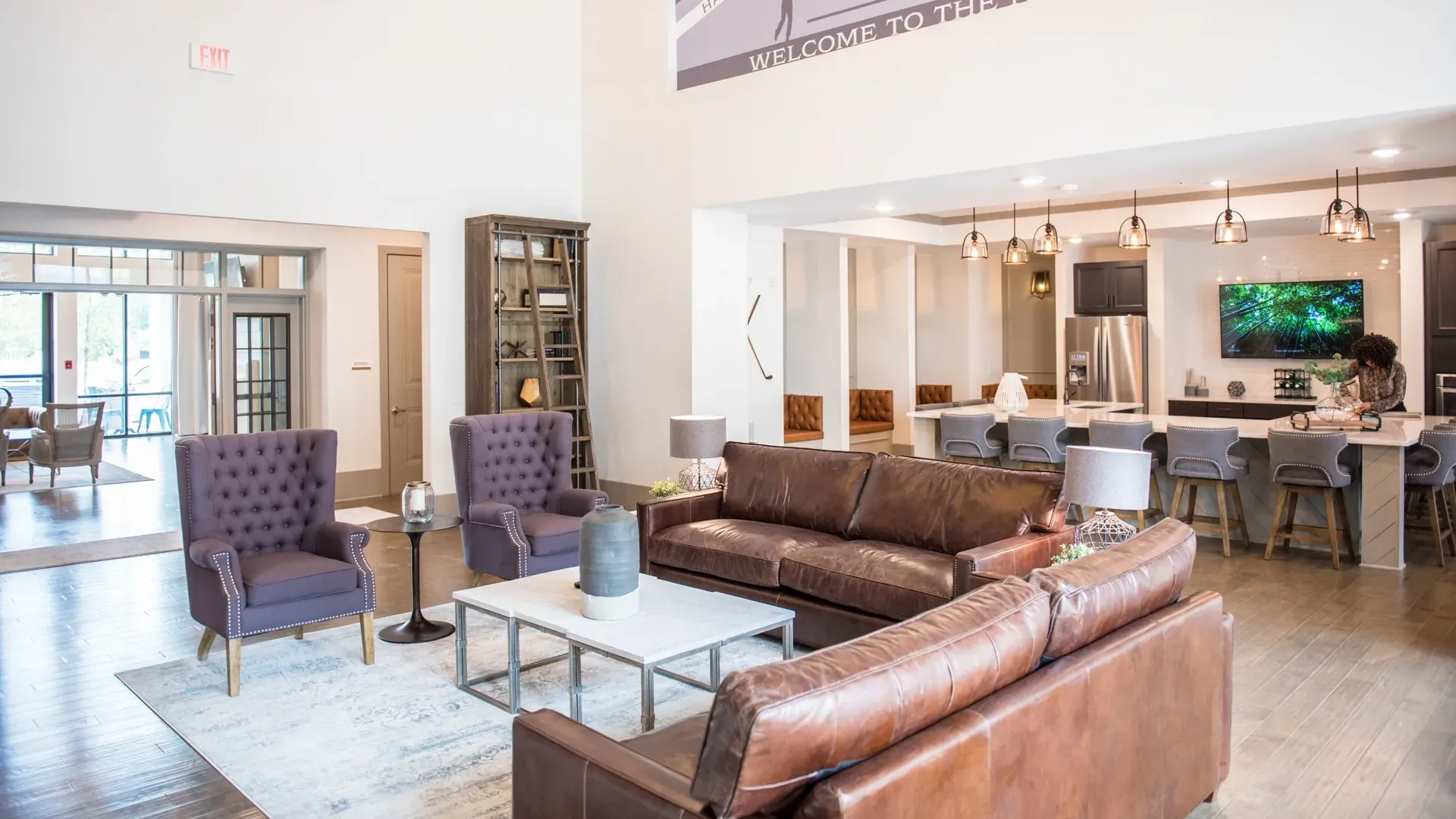Lobby seating area with comfortable couches and armchairs, and a full-service kitchen island.