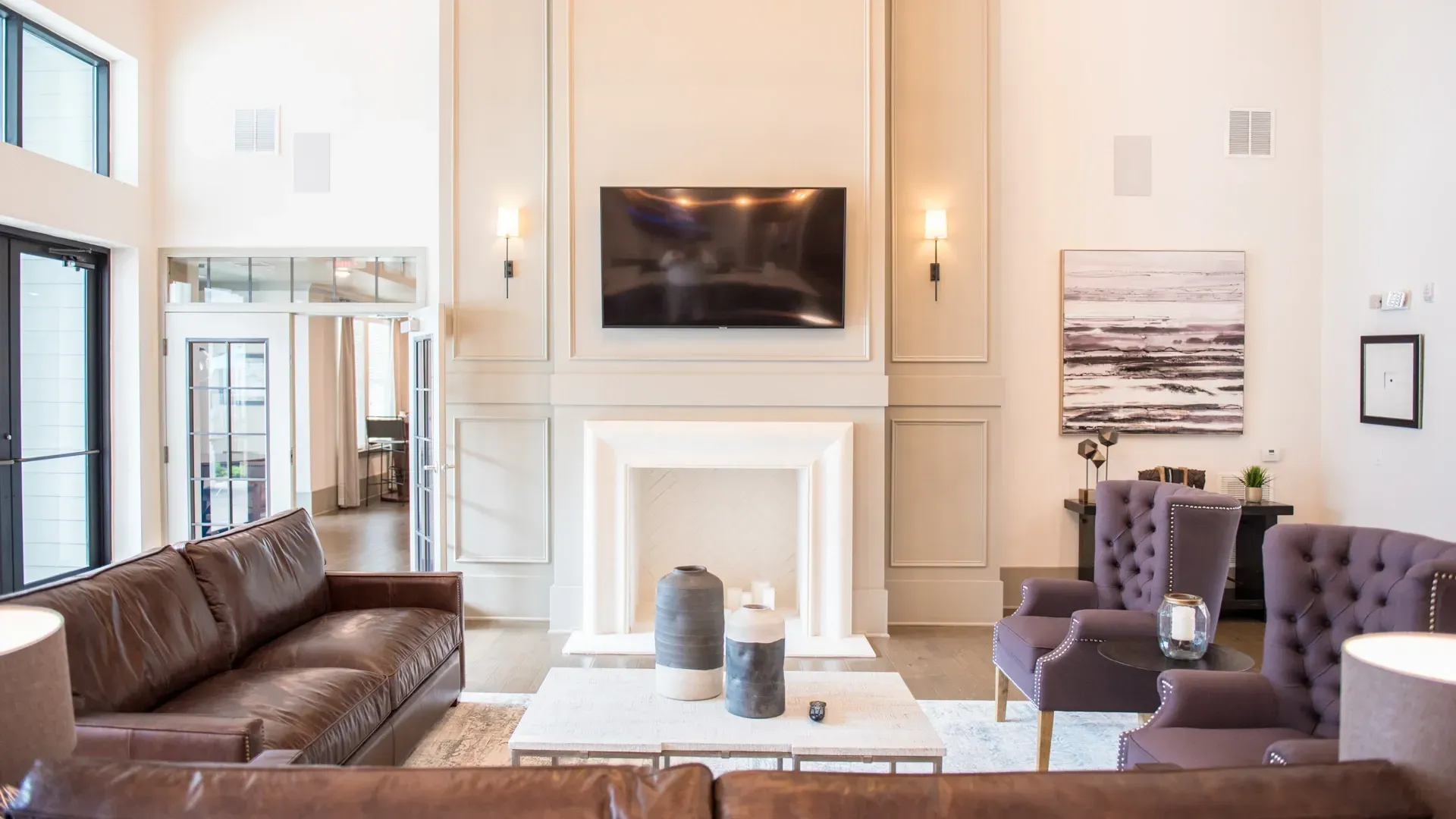 Spacious lounge area with a fireplace, large TV, and comfortable seating.