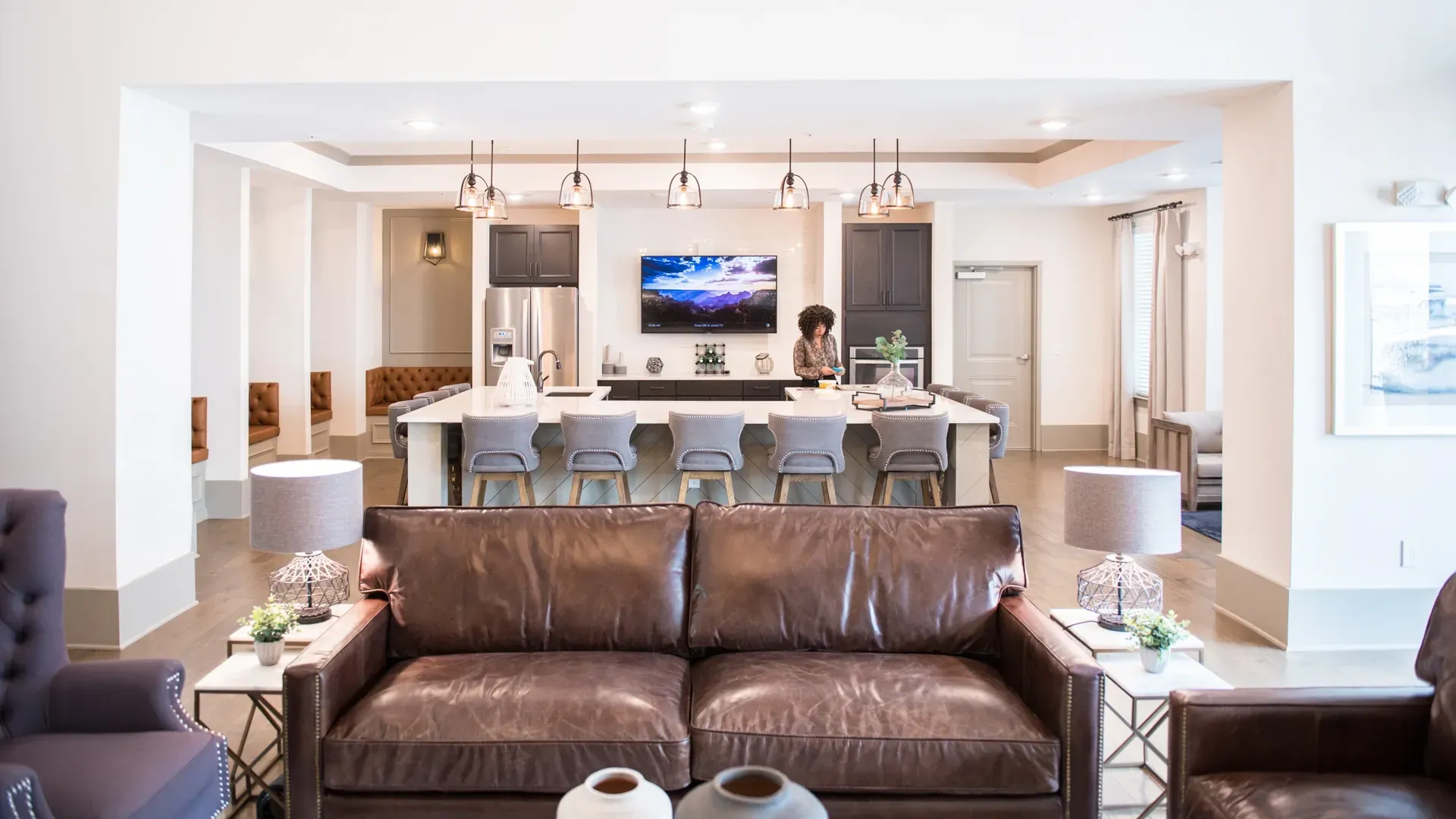 Spacious modern communal lounge with a large island kitchen and comfortable seating.