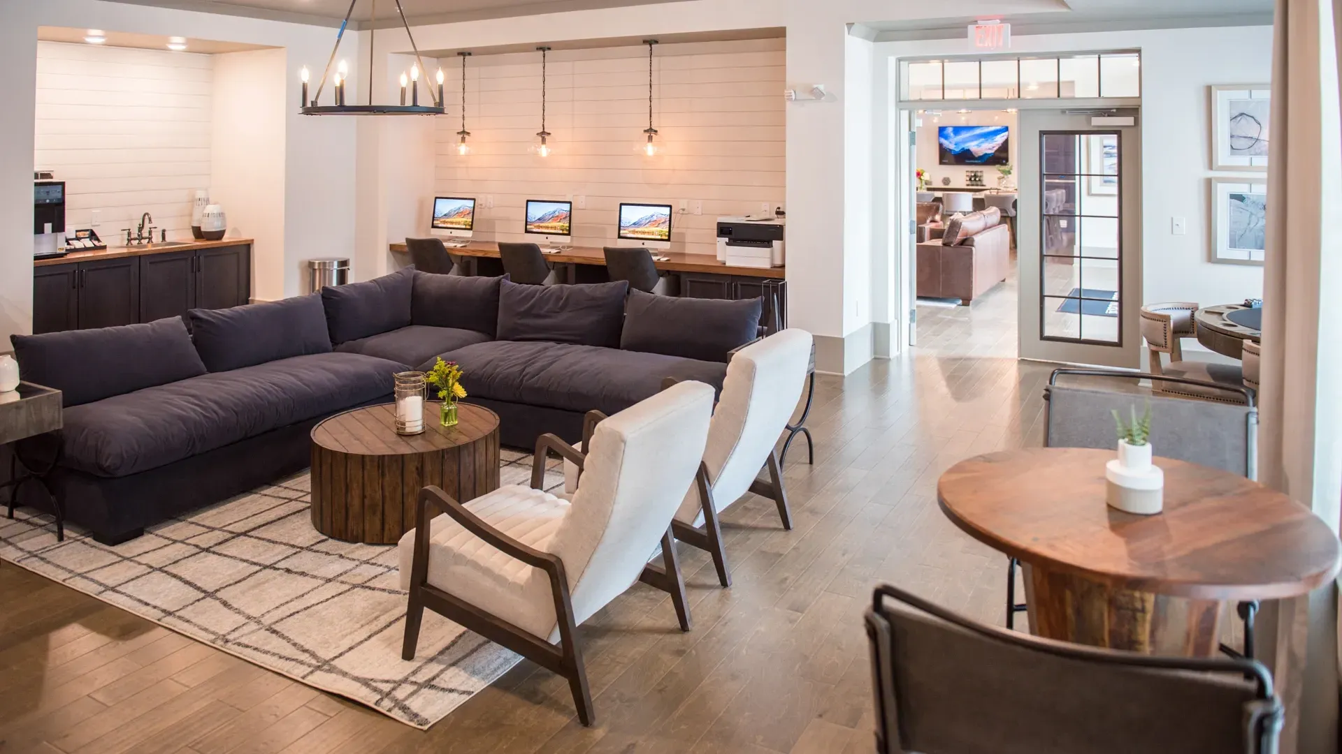 Community lounge area with computers, seating, and coffee bar.