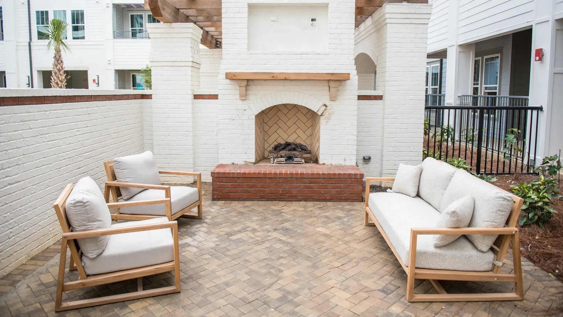 Outdoor living space with fireplace and seating.
