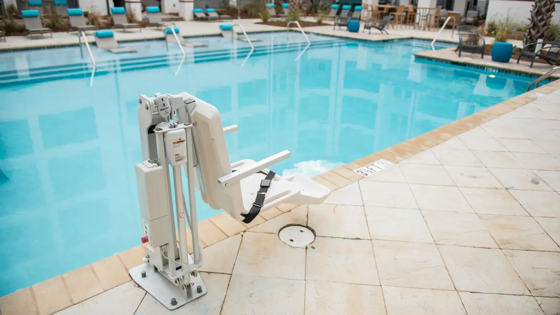 Swimming pool with a pool lift for accessibility