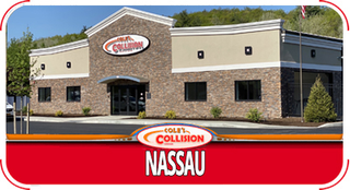 Collision Nassau auto body shop exterior with tan and stone facade and red signboard
