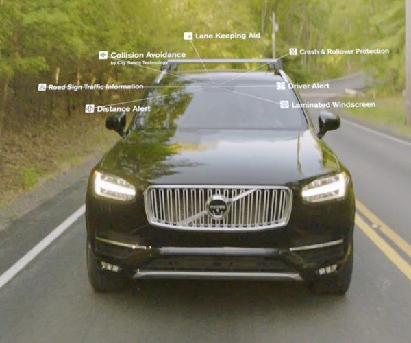 Black Volvo SUV driving on a wet road with labels for safety features and sensors.