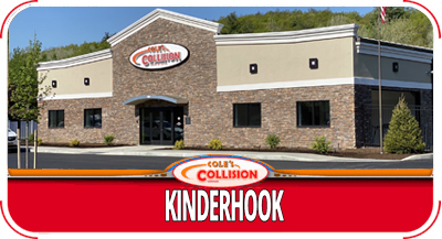 Kinderhook Collision storefront with red sign and beige stone facade