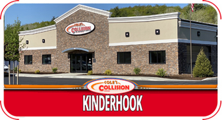 Kinderhook Collision storefront with red sign and beige stone facade