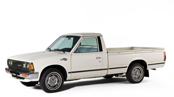 White vintage pickup truck in side view on a plain white background