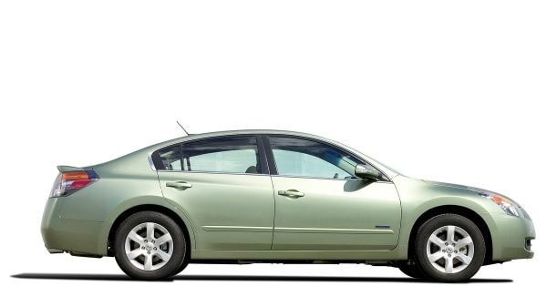 Side view of a light green sedan car on a white background