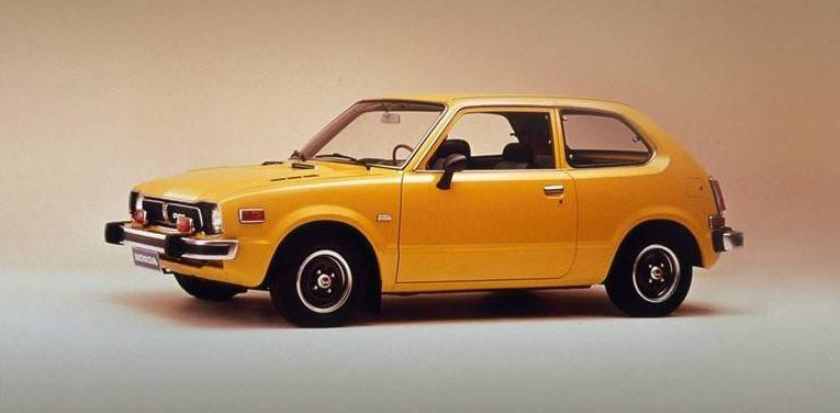 Yellow vintage hatchback car in side view on a plain background