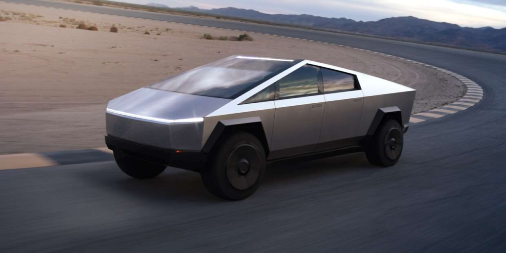 Silver futuristic pickup truck driving on a desert road
