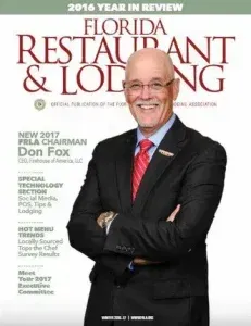 Magazine cover with smiling man in black suit and red tie, titled Florida Restaurant & Lodging