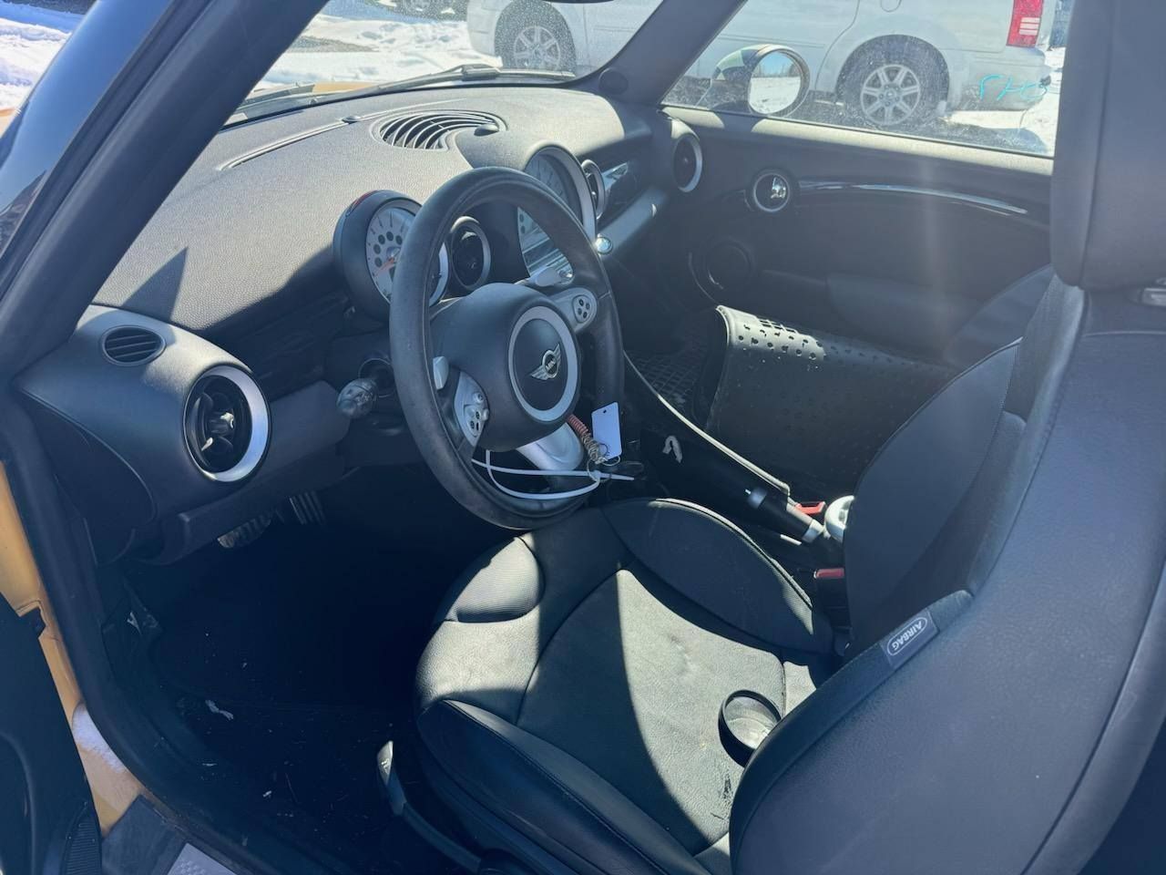 The interior of a mini cooper with the door open