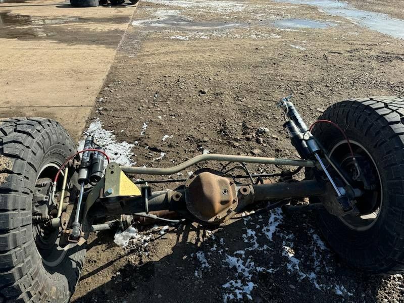 The front end of a truck is laying on the ground