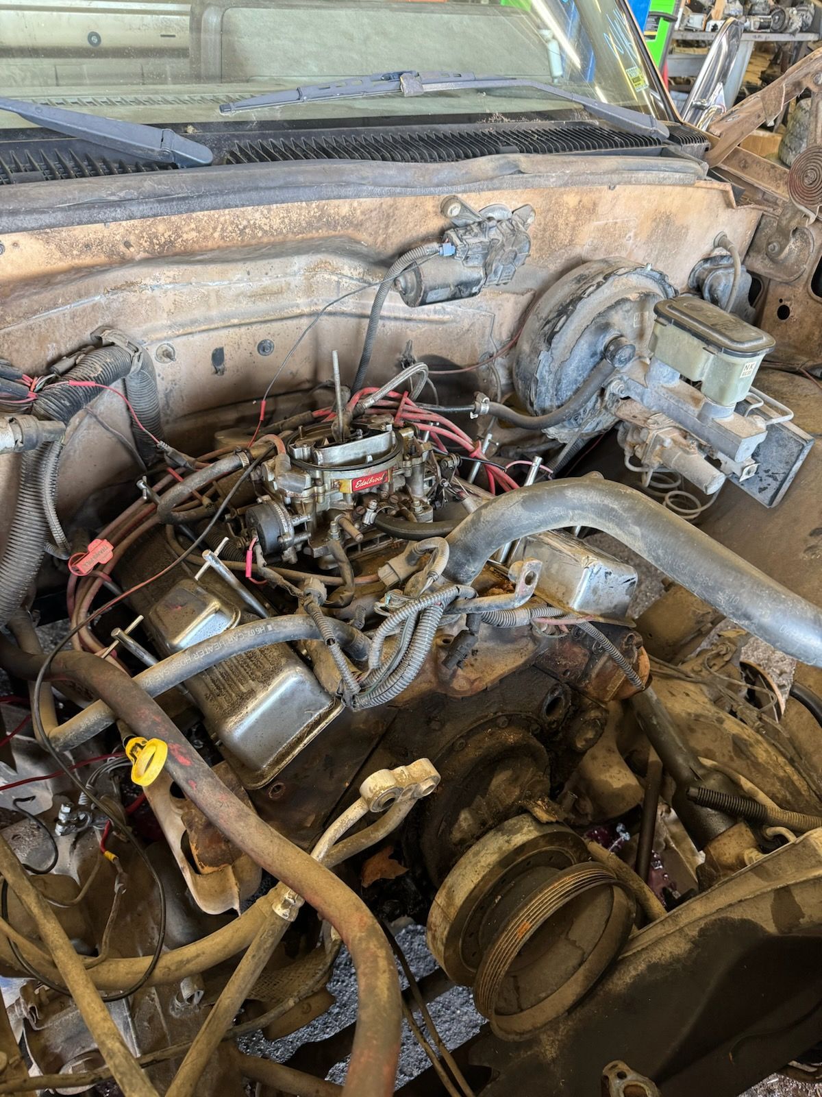 A close up of a car engine with a lot of wires coming out of it.