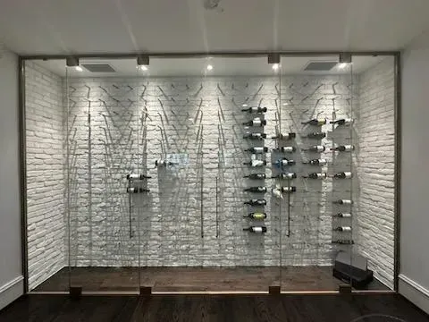 Eyeglass display wall with rows of frames on wire racks in a store showroom