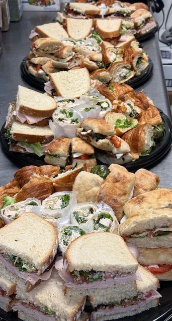 There are many different types of sandwiches on the plates.