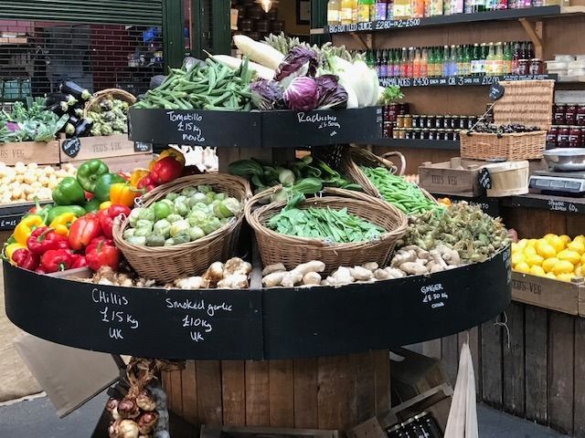 A display of fruits and vegetables on a table in a store.