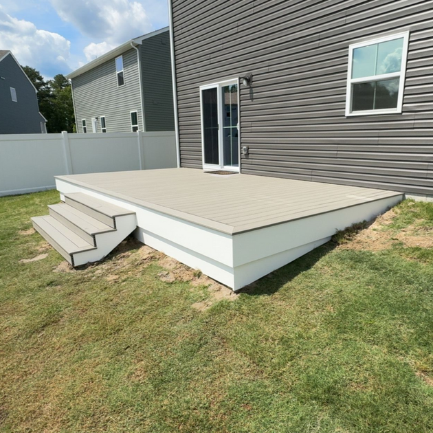 A wooden deck with a table and bench under a pergola.