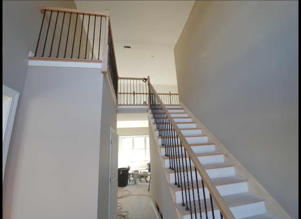 There is a desk under the stairs in the basement.