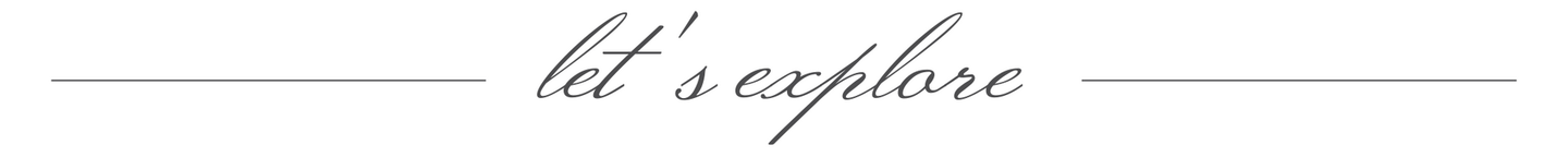 Handwritten “let’s explore” centered between two thin horizontal lines on a light background