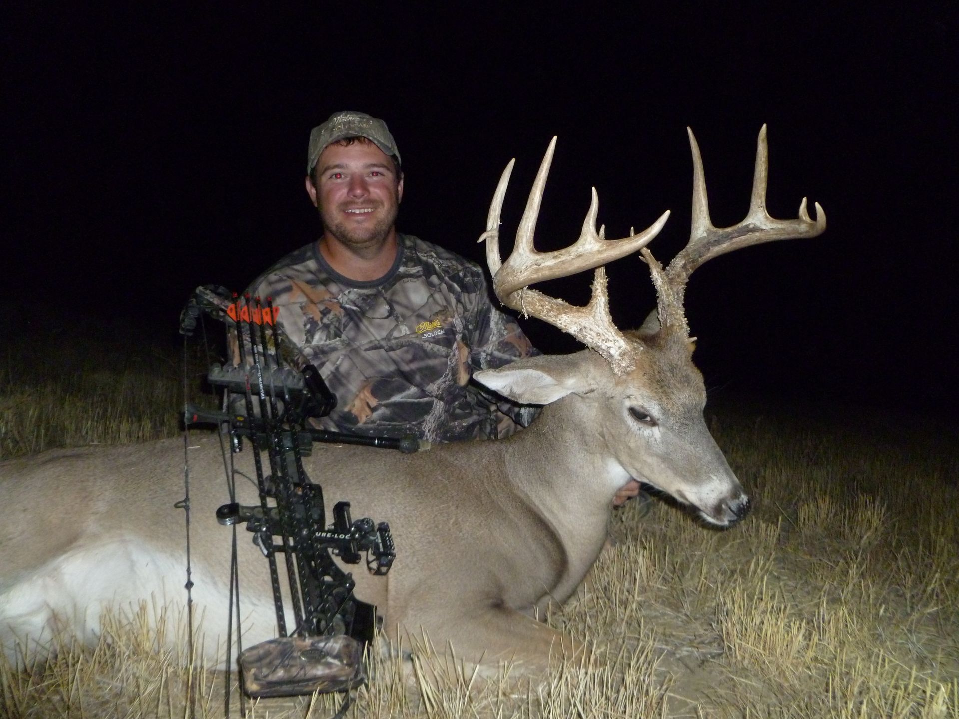 A man smiling with a dead deer