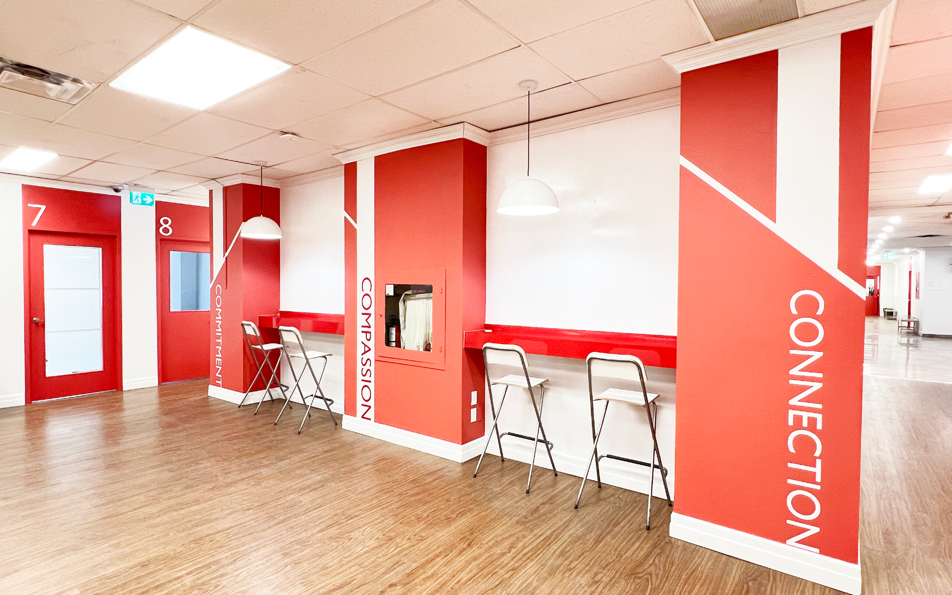 Red and white interior with connection signage, counters, bar stools, and doors.