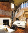 A living room with a couch , fireplace , and stairs.