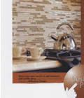 A blurred image of a kitchen counter with a tea kettle on it.
