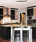 A kitchen with a large island and stools.