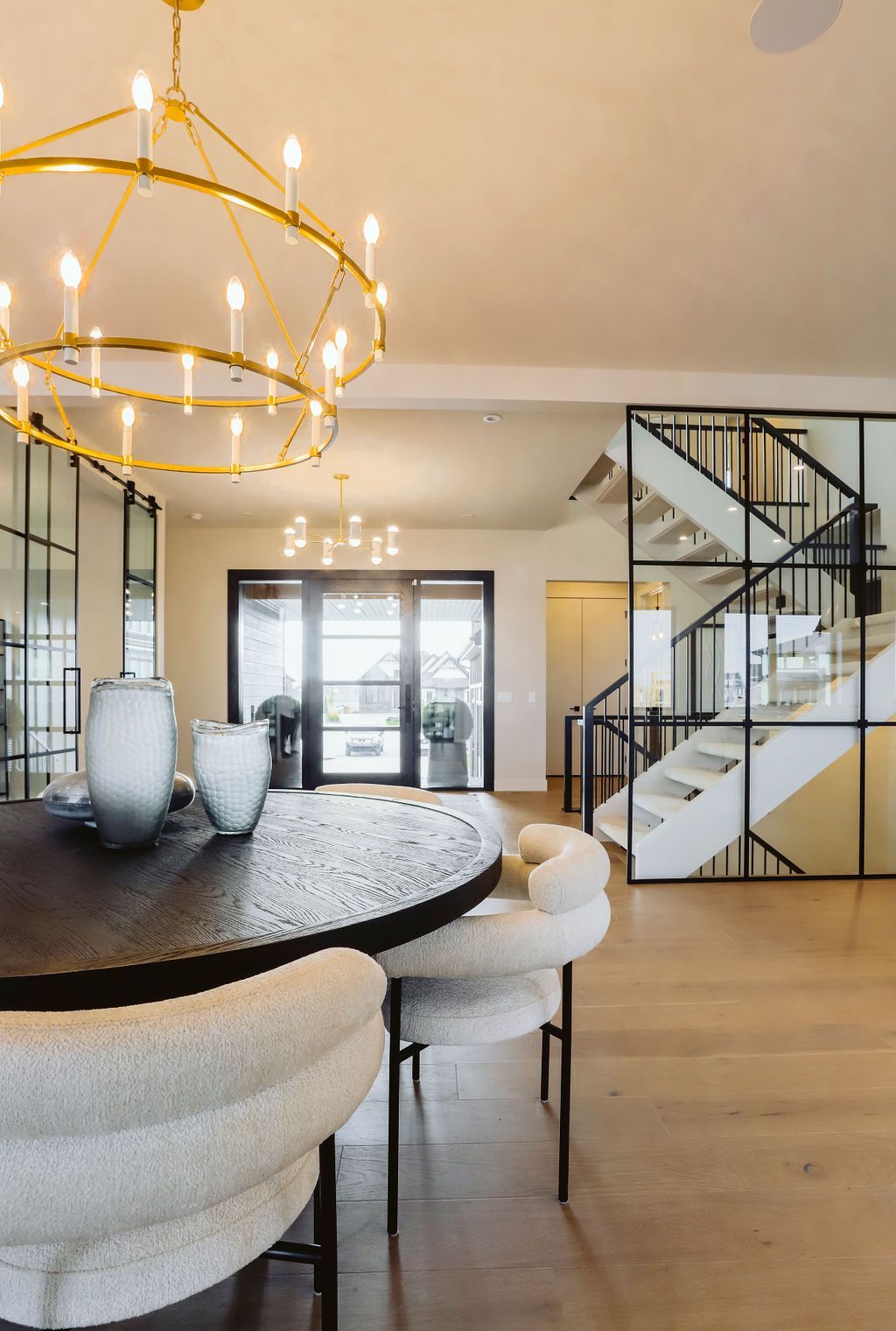 A dining room with a table and chairs and a chandelier.