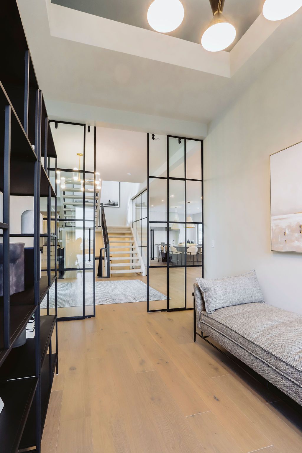 A living room with a couch and stairs in the background.