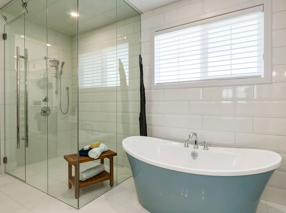 A bathroom with a bathtub and a walk in shower.