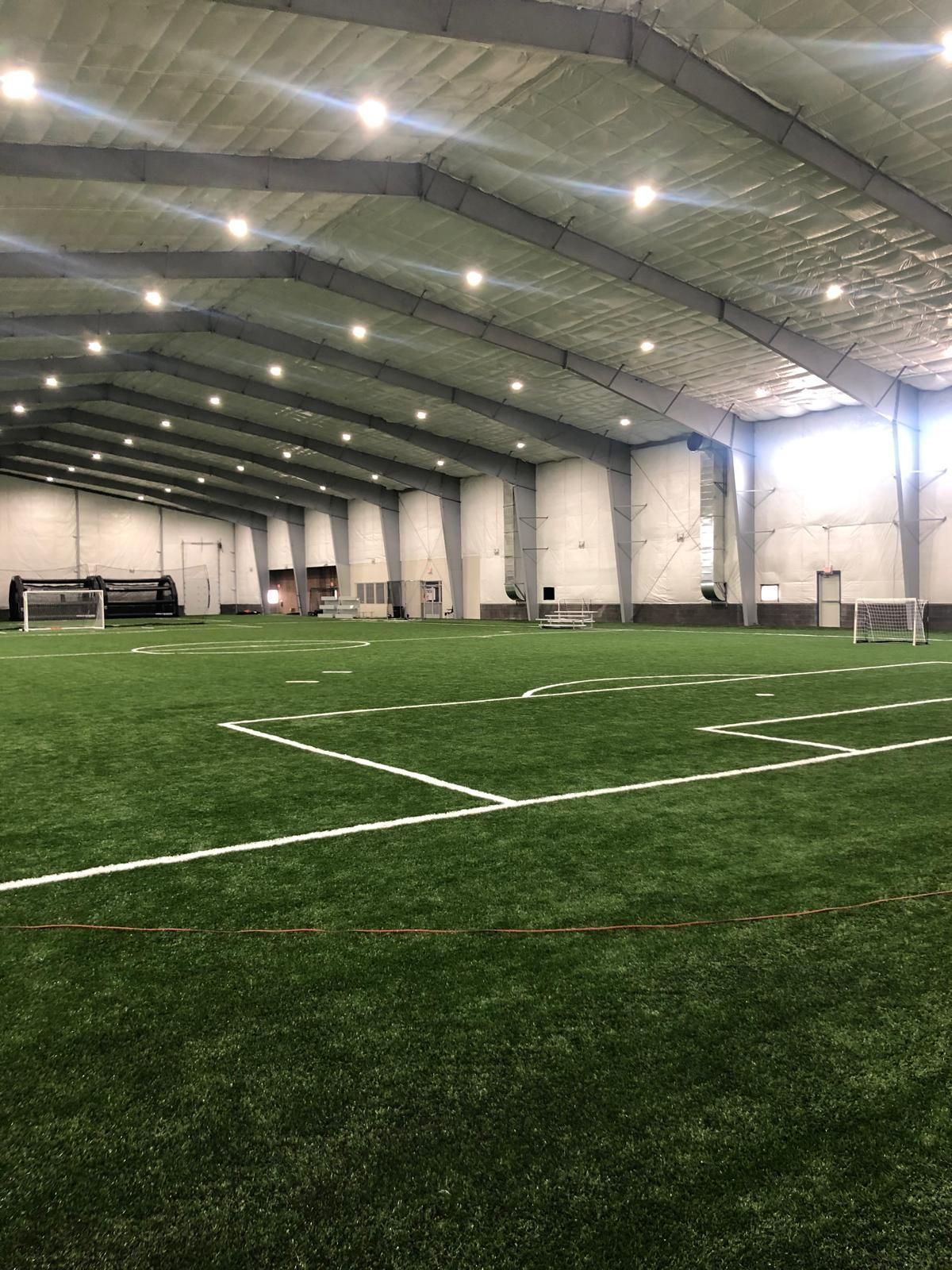 There is a soccer field inside of a building.