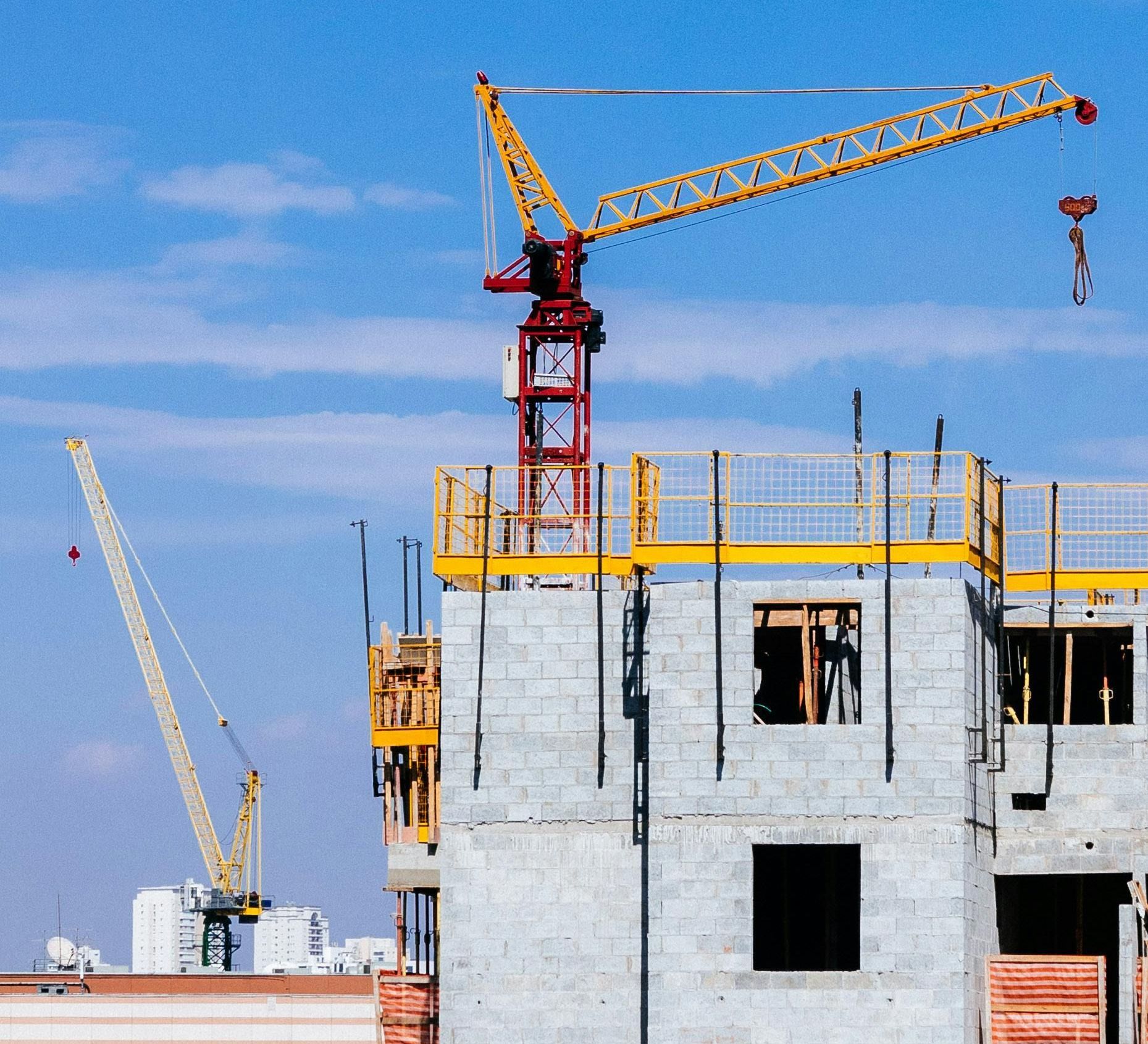 A building under construction with a crane in the foreground