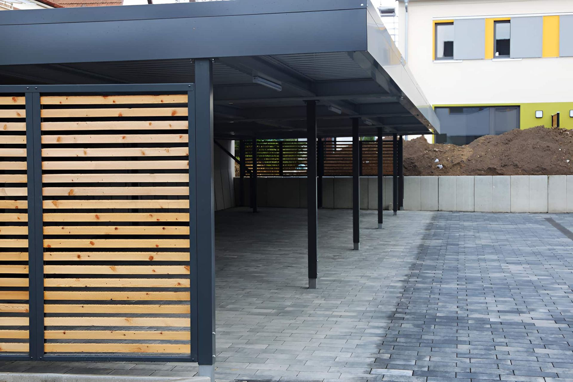 A Carport With Wooden Slats on the Side of It — Pride Carpentry & Maintenance In Lake Macquarie, NSW