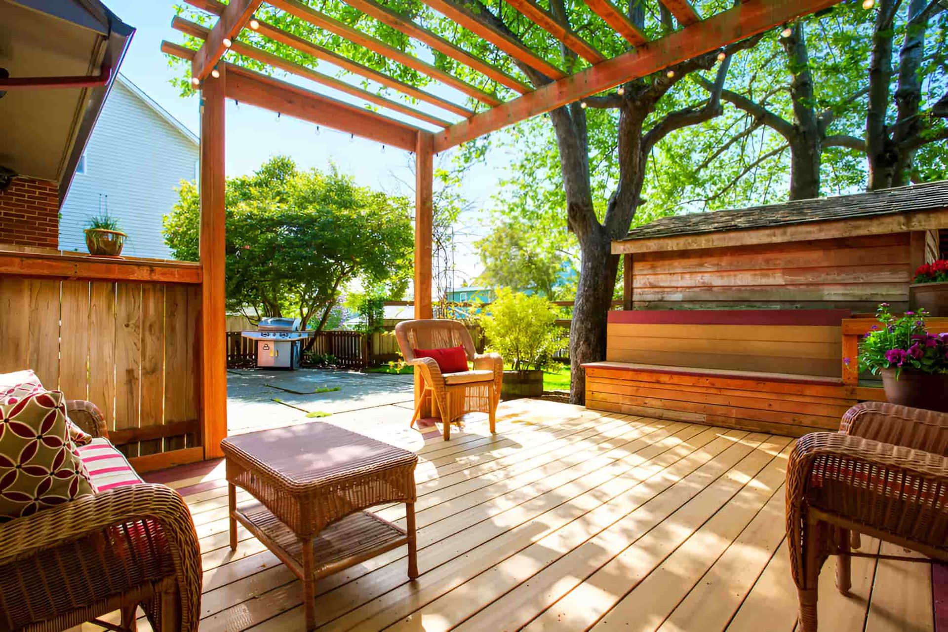 Wooden Deck Featuring Wicker Furniture and a Pergola — Pride Carpentry & Maintenance In Berkeley Vale, NSW