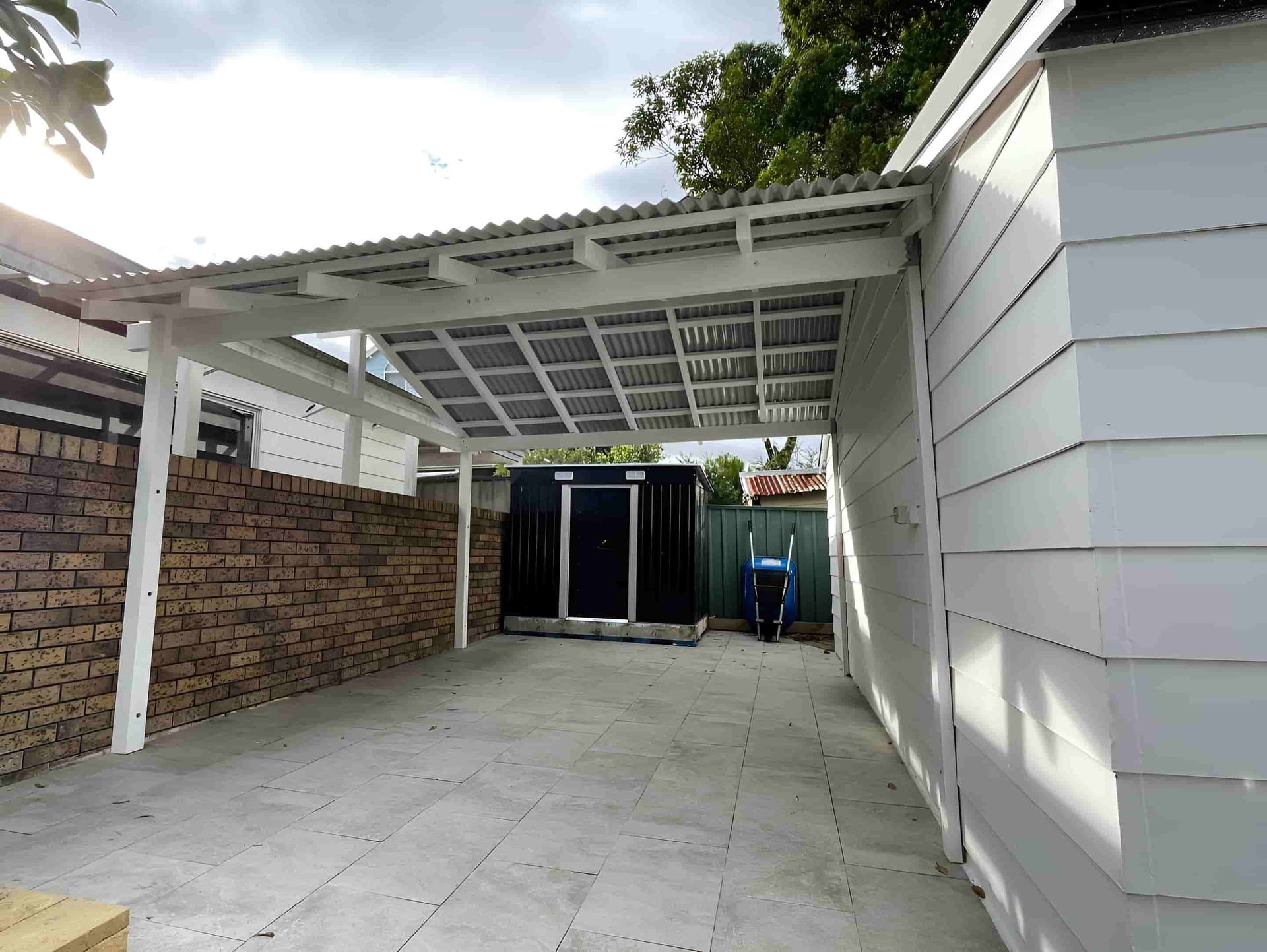 A White Carport Providing Shelter for Vehicles — Pride Carpentry & Maintenance In Berkeley Vale, NSW