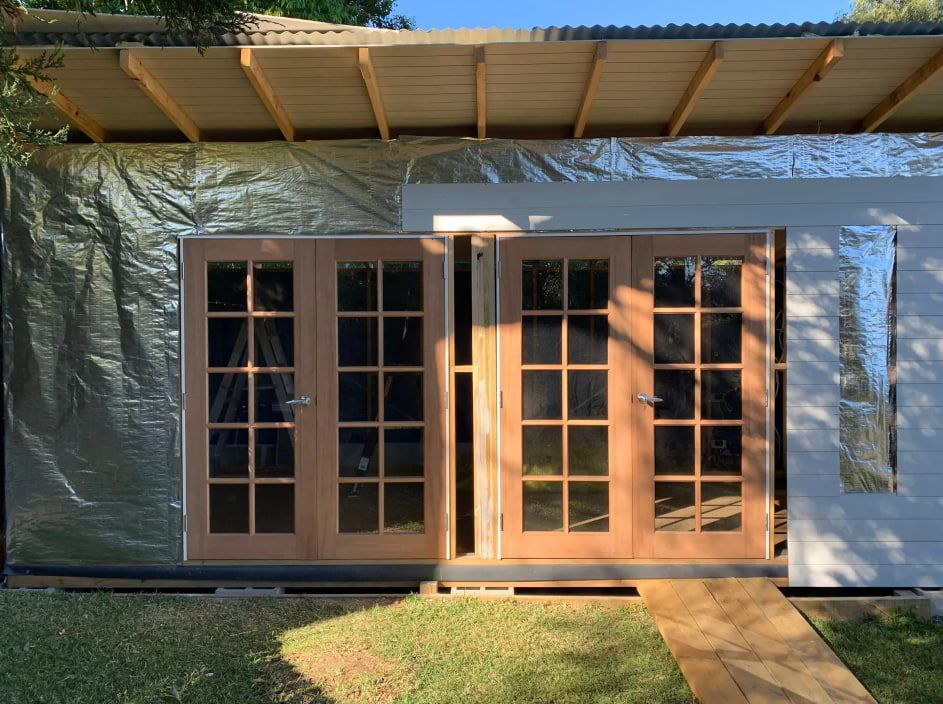 A House With Two Doors and Wall Covered in Plastic — Pride Carpentry & Maintenance In Berkeley Vale, NSW