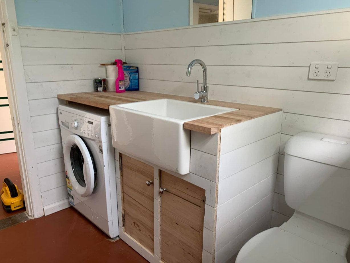 A Bathroom With a Sink and a Washer — Pride Carpentry & Maintenance In Berkeley Vale, NSW