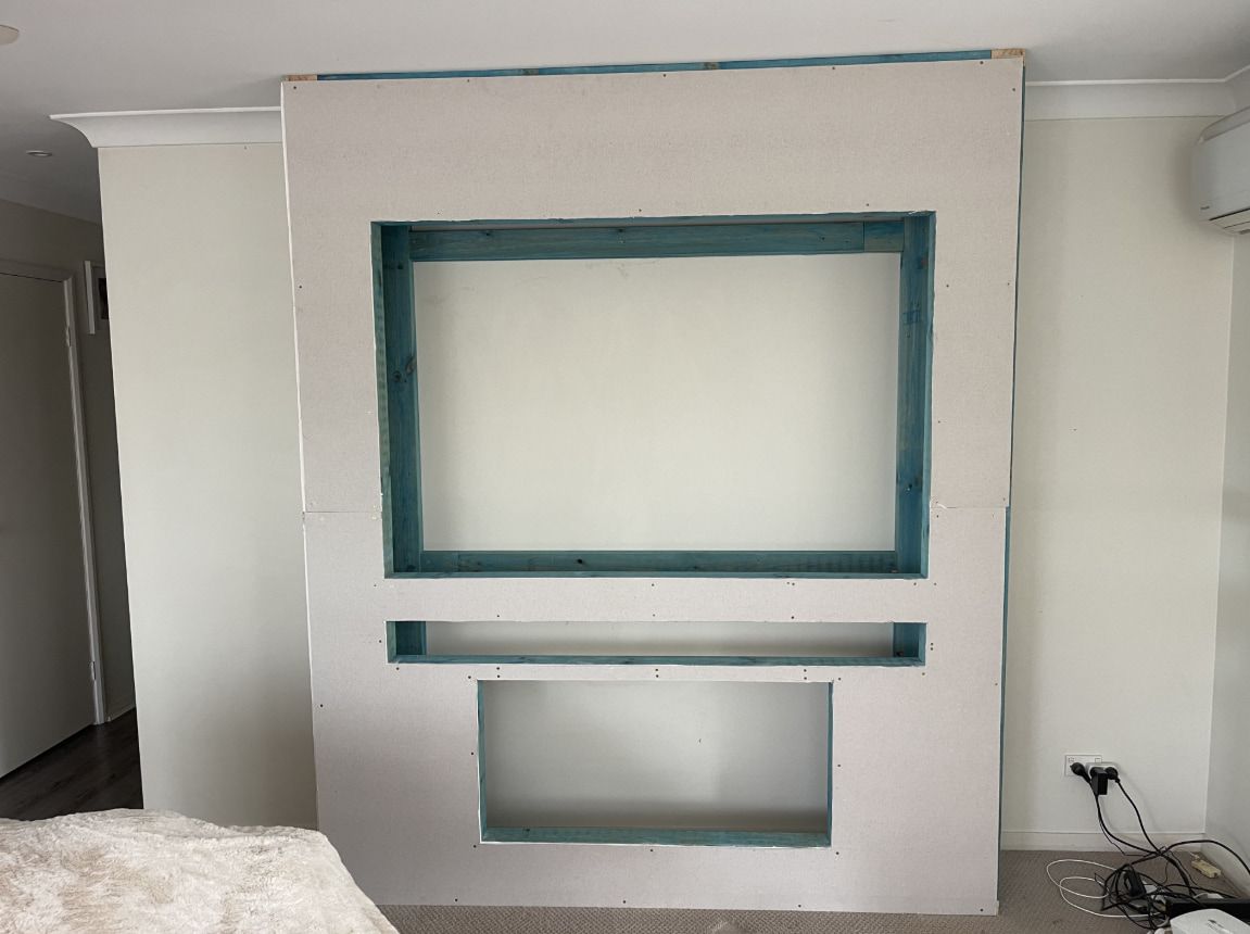 A White Wall With a Blue Shelf — Pride Carpentry & Maintenance In Berkeley Vale, NSW