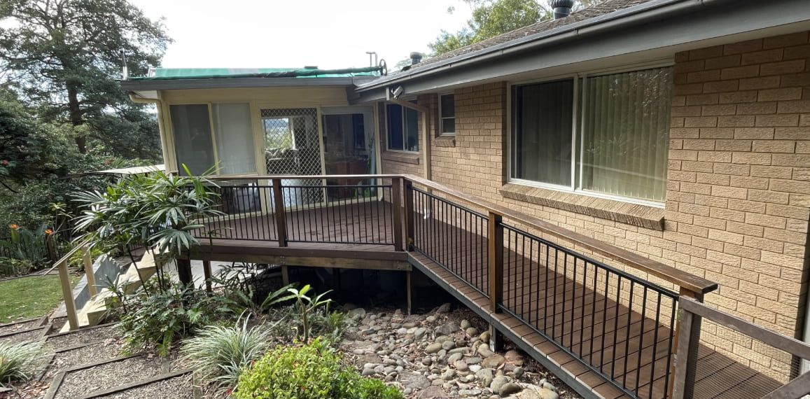 A Brick House With a Wooden Deck — Pride Carpentry & Maintenance In Lake Macquarie, NSW