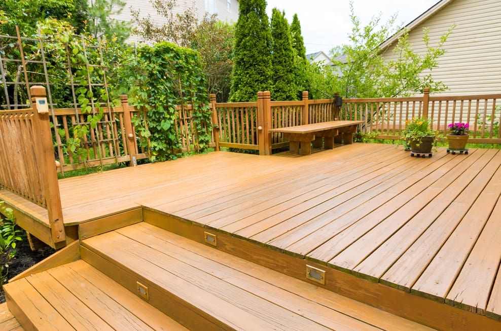 A Wooden Deck With Stairs and a Bench — Pride Carpentry & Maintenance In Lake Macquarie, NSW