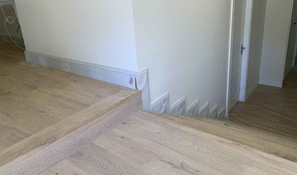 A Room With a Wooden Floor and a White Wall — Pride Carpentry & Maintenance In Lake Macquarie, NSW