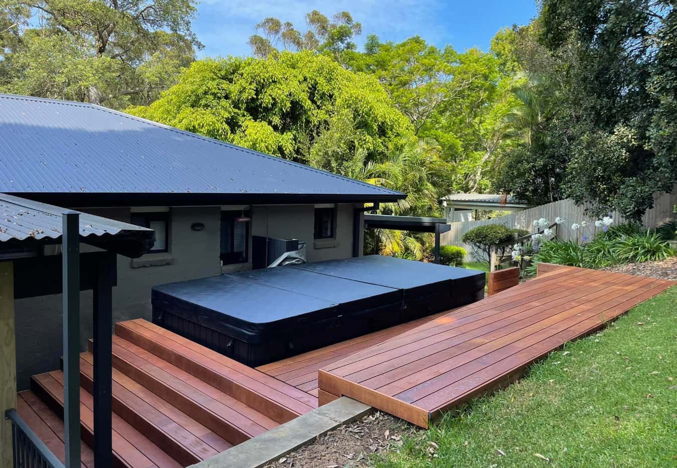 There is a Hot Tub on the Deck of a House — Pride Carpentry & Maintenance In Berkeley Vale, NSW