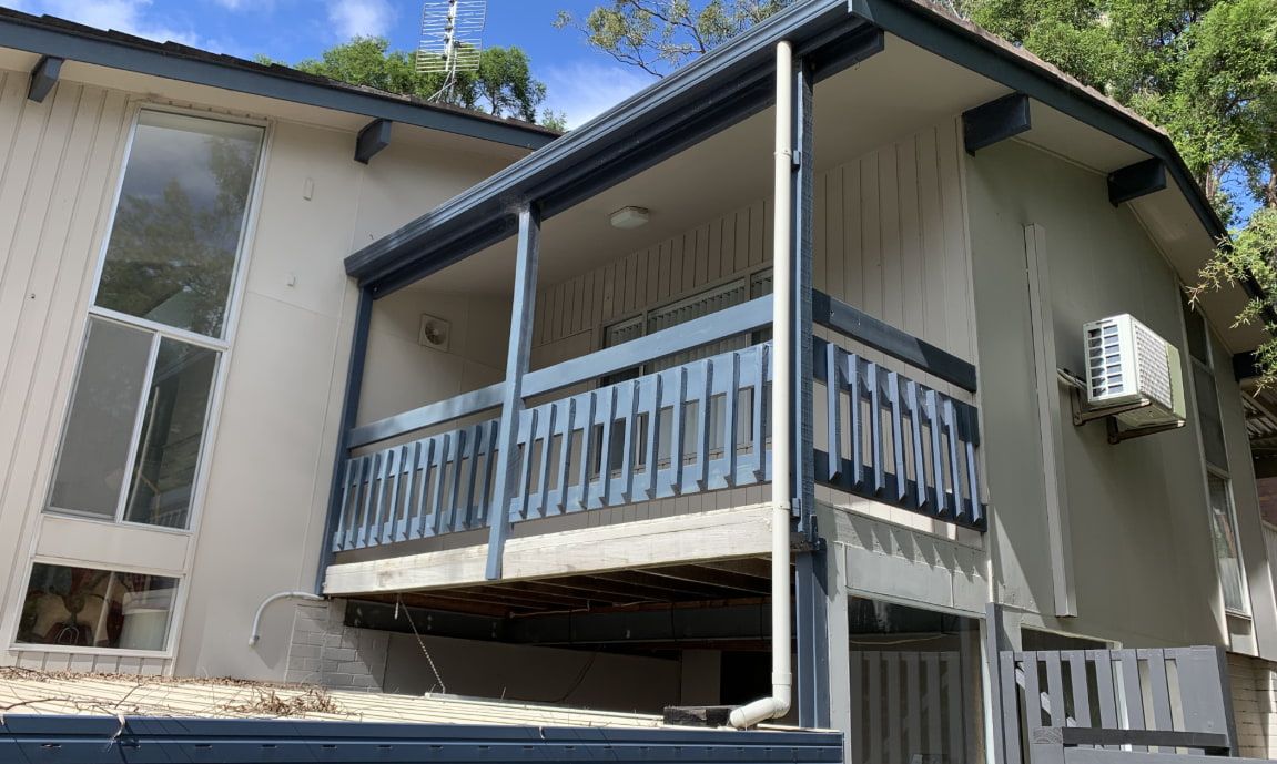 A House Featuring a Balcony With a Railing — Pride Carpentry & Maintenance In Berkeley Vale, NSW