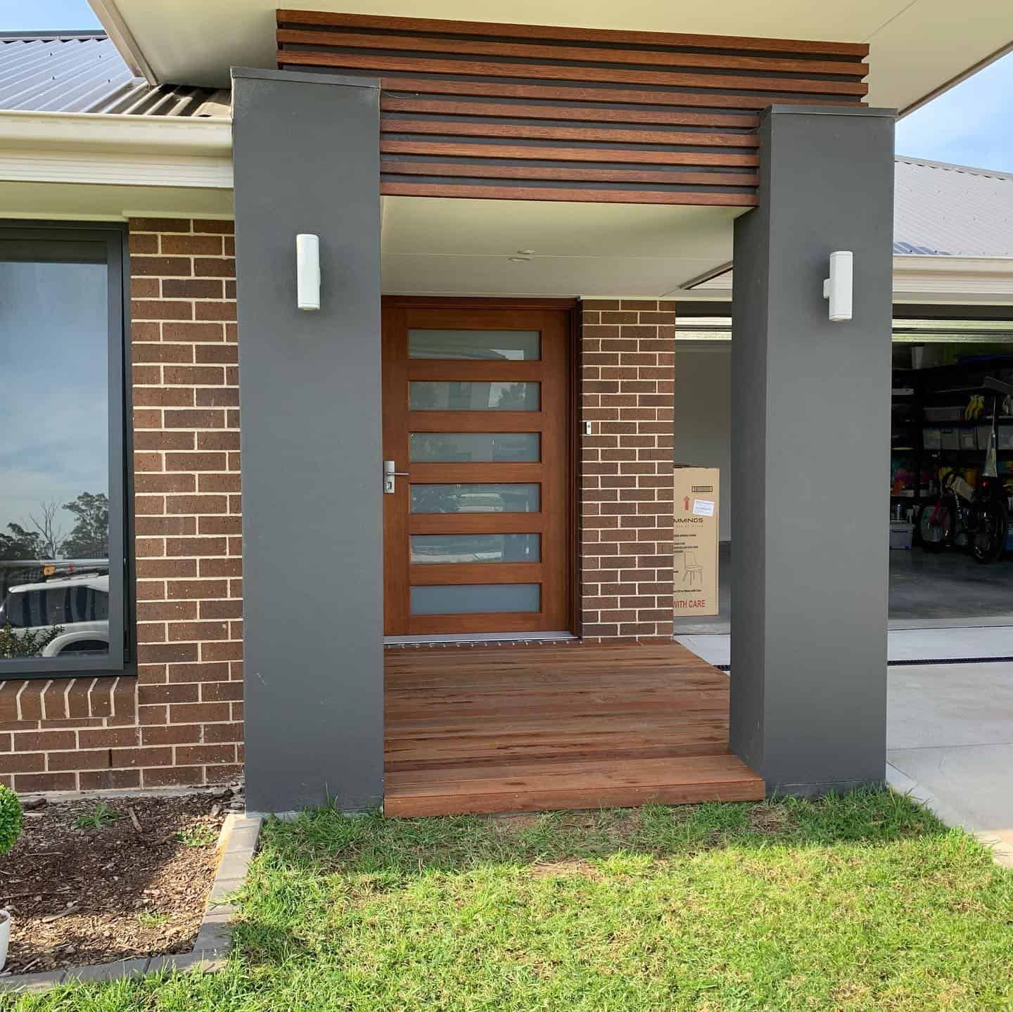 Modern Home Featuring a Wooden Front Door — Pride Carpentry & Maintenance In Berkeley Vale, NSW