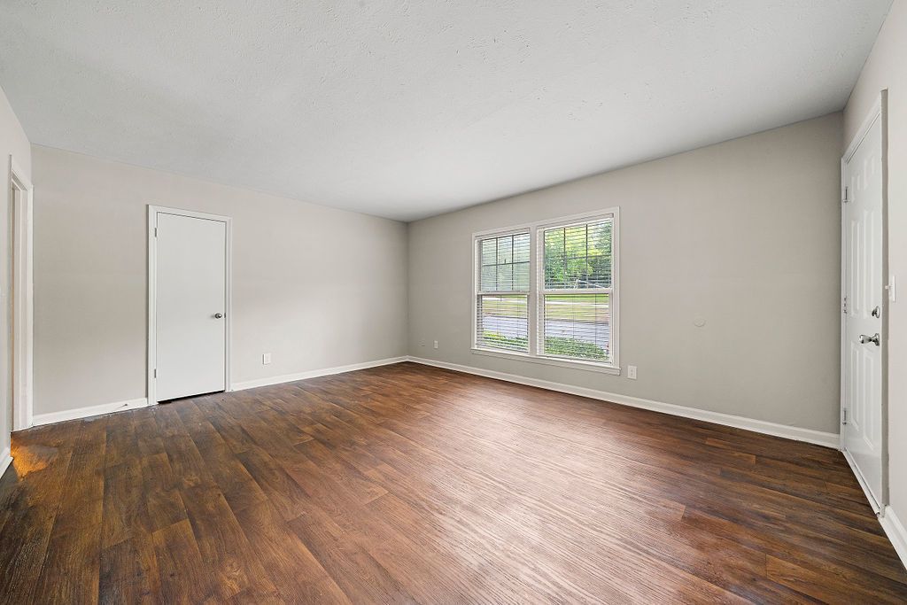 living room with hardwood-style vinyl flooring