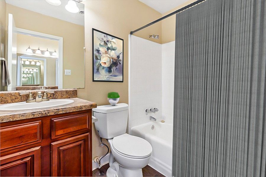 bathroom with wood cabinets and virtually staged