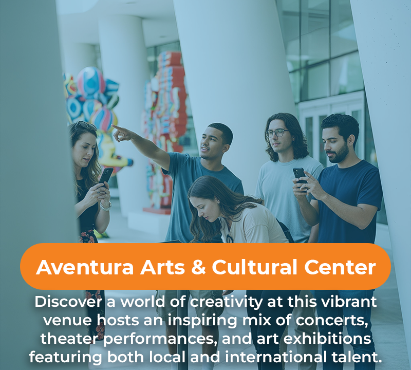 People exploring art, pointing and using phones, at the Aventura Arts & Cultural Center.